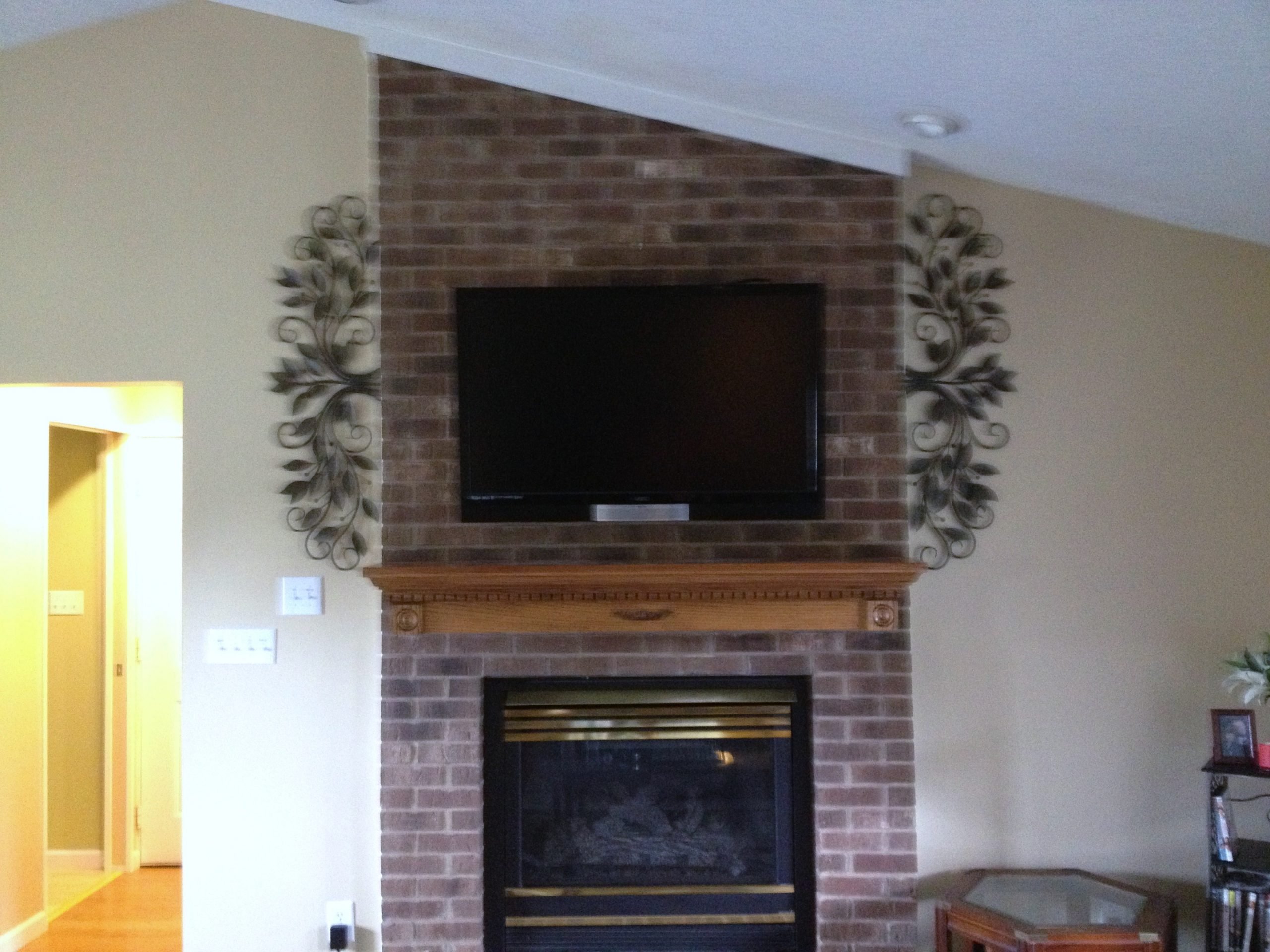 TV Mounting over a fireplace with wires concealed in the ...